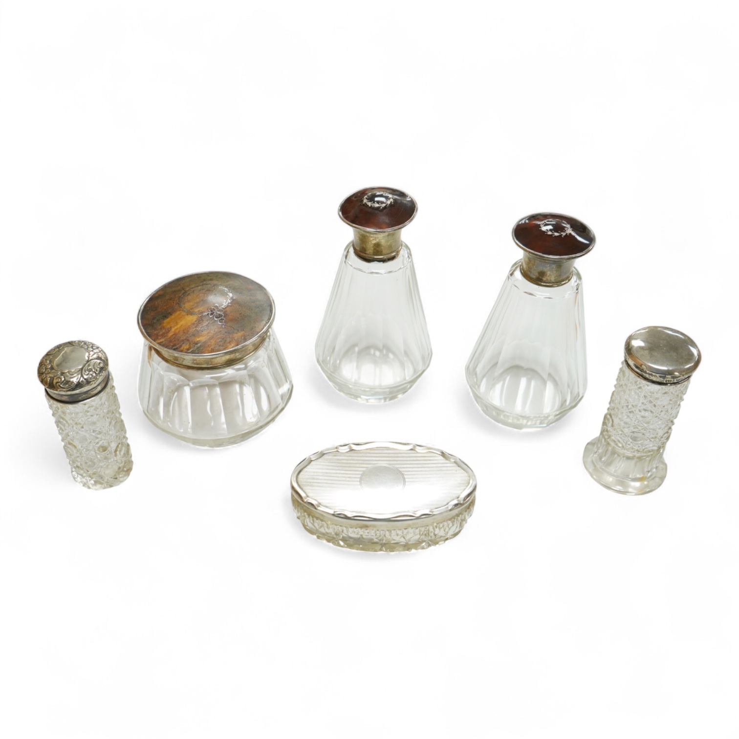 Three George V silver and tortoiseshell mounted glass toilet jars, Adie Brothers, Birmingham, 1925 & 1927, together with three other silver mounted glass toilet jars.